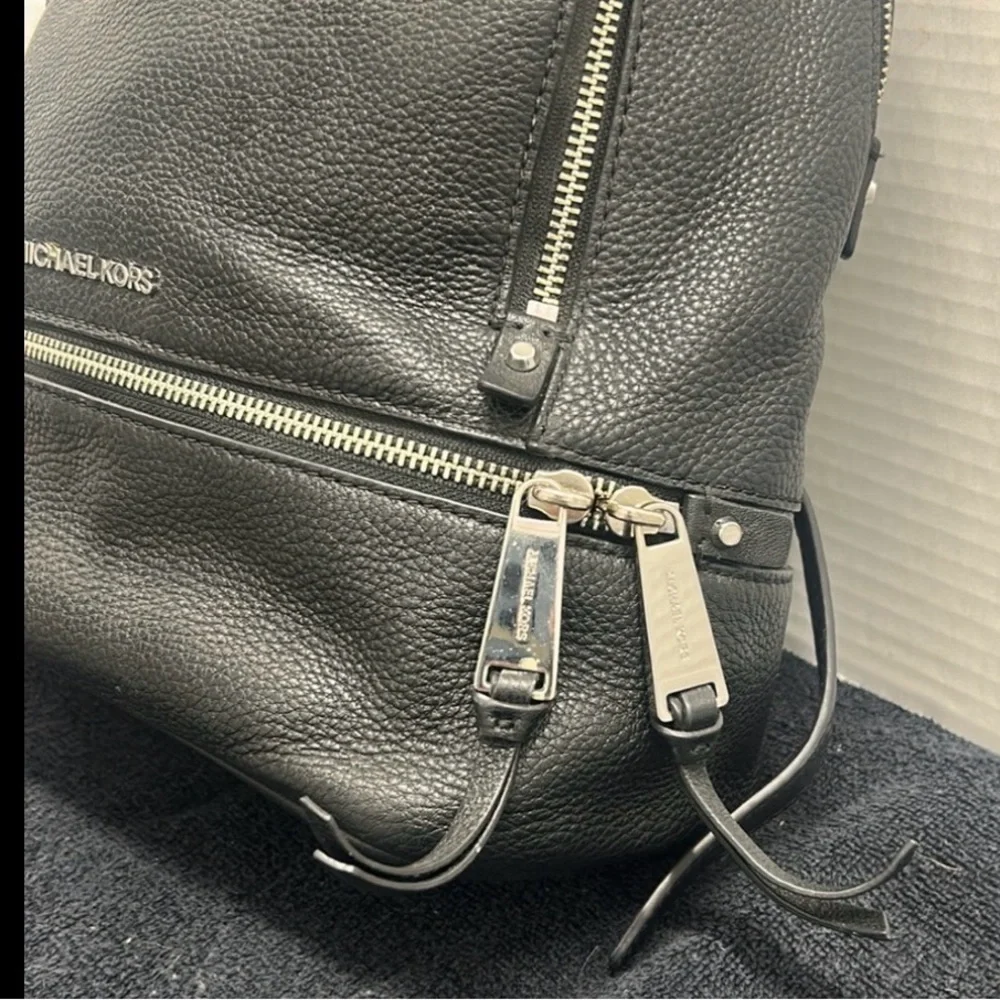 Michael Kors Rhea Medium Backpack in black pebbled leather  silver-tone dust bag